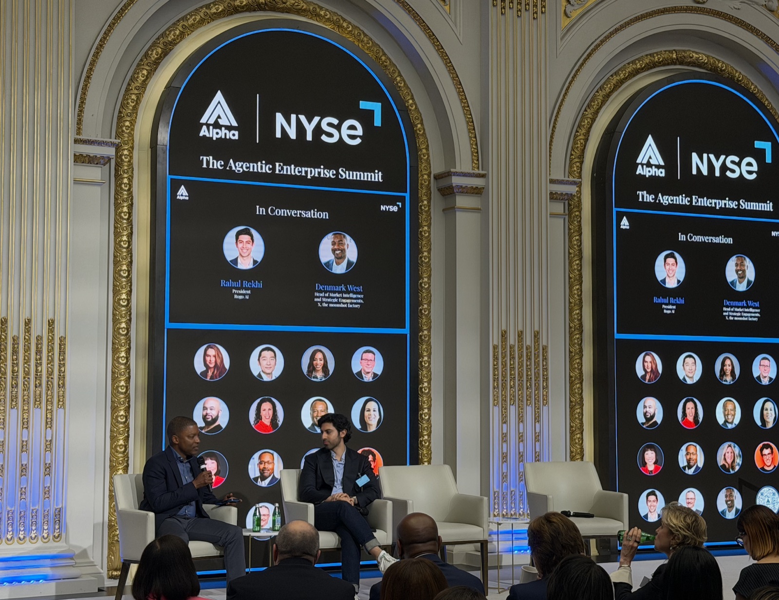 Two speakers in conversation onstage at Alpha's Agentic Enterprise Summit.