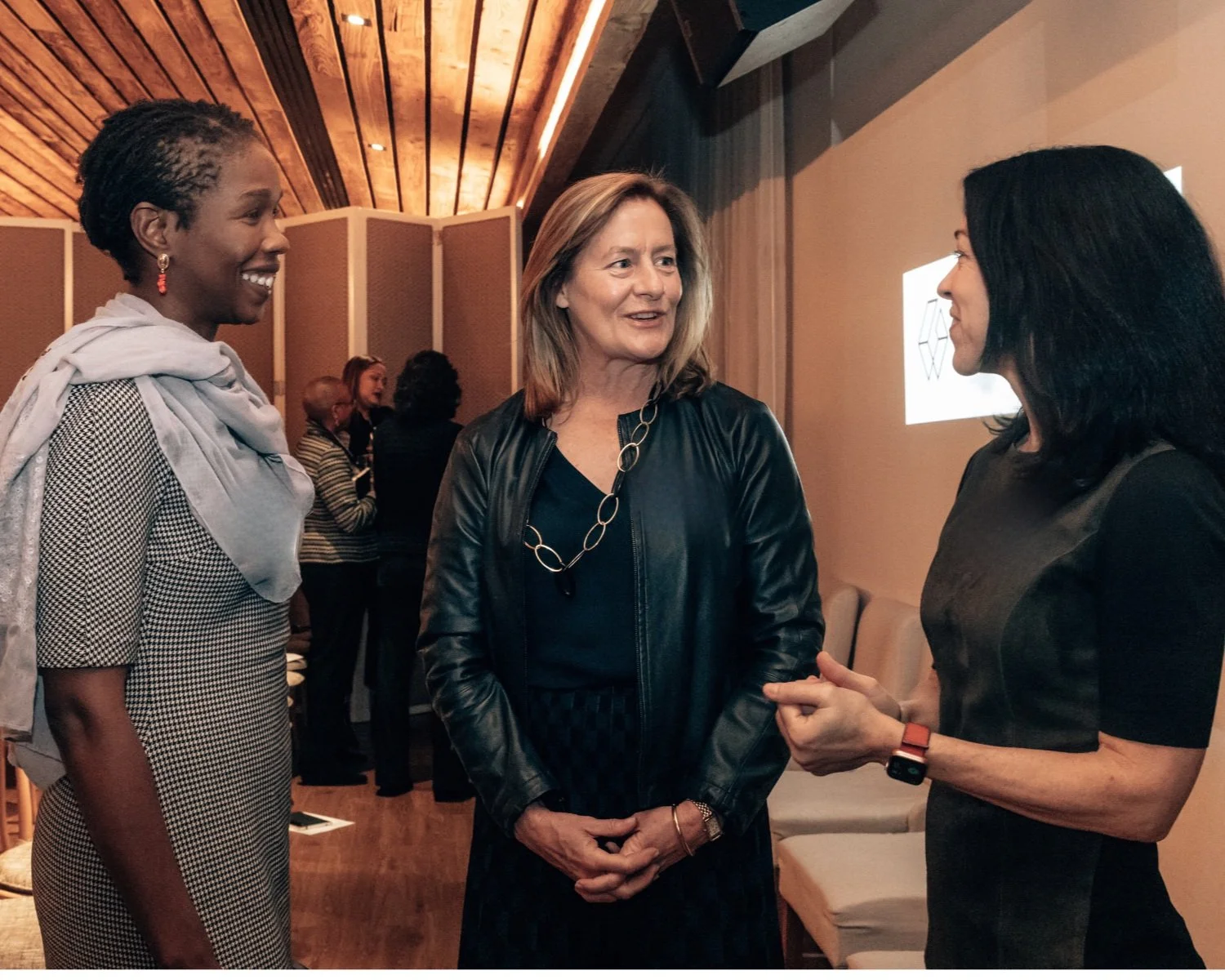 Three board leaders exchange perspectives during an Alpha Institute AI Boardroom Lab.